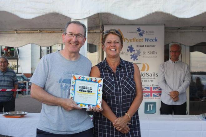 Pete Purkiss claims his RS700 prize from Sue Bouckley of Learning and Skills Solutions Pyefleet Week ©  Mandy Bines
